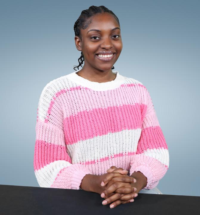 Kayla Williams smiling in striped shirt for picture