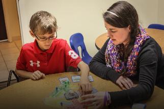 Teacher working with young student